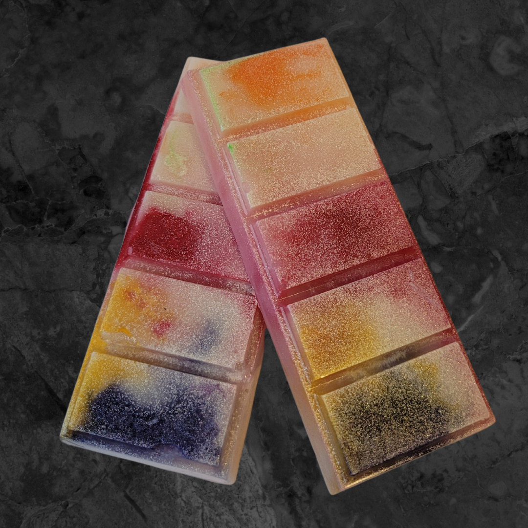 Multicoloured soy wax melt snap bar melt. Orange, cream, red, yellow, green and violet coloured wax.