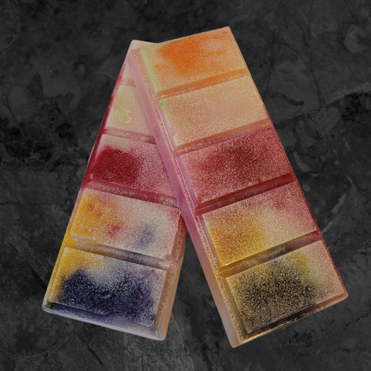 Multicoloured soy wax melt snap bar melt. Orange, cream, red, yellow, green and violet coloured wax. 